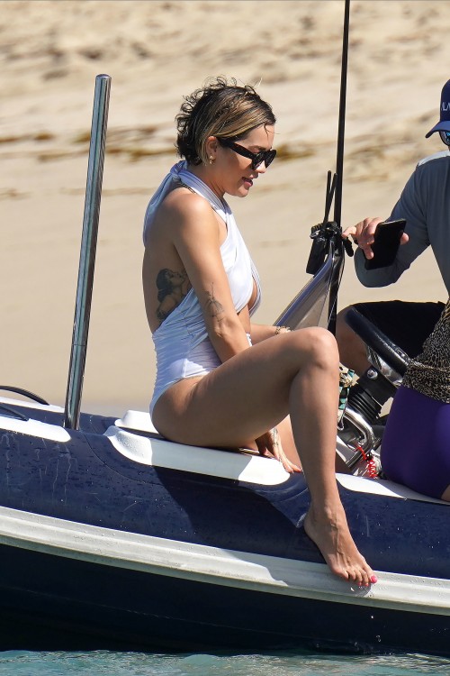 EXCLUSIVE: Rita Ora in a white wrap around swimsuit spending holiday season with her family in St-Ba