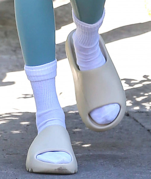 Kendall Jenner wears white socks with Yeezy Slides in Bone