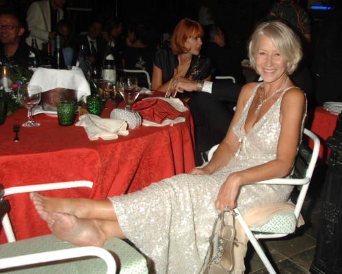 September 2nd 2006, Helen Mirren gets her shoes off and relaxes at the party  after the Queen Premie